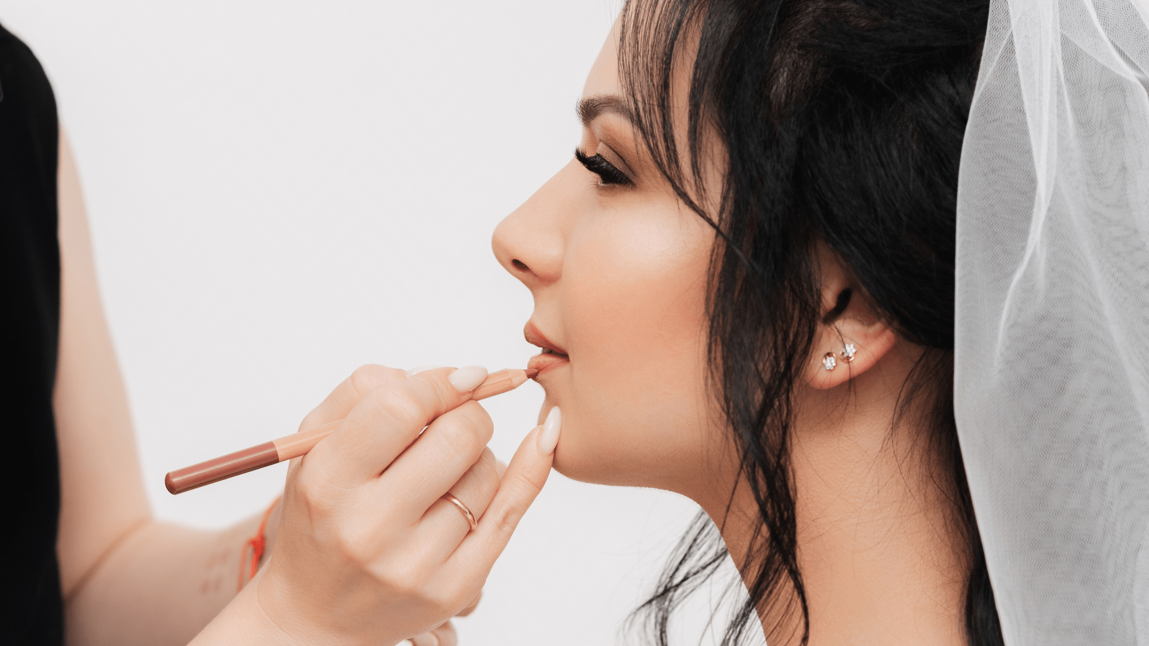 Woman getting makeup done for wedding — bridal prep Anchorage