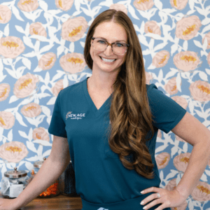 brie smiling standing in front of floral background