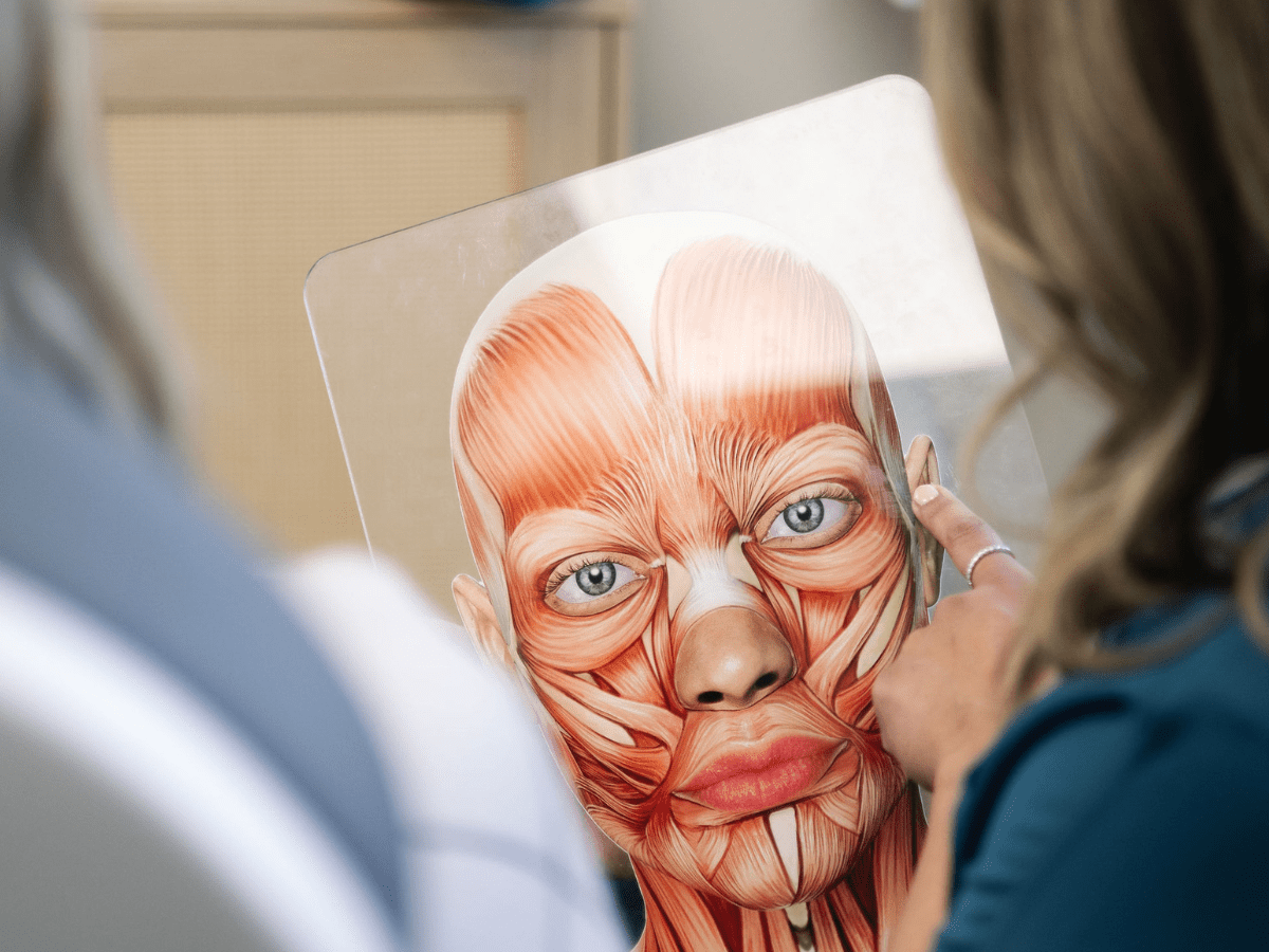 Natasha Sherrill explaining facial structure during a facial balancing consultation