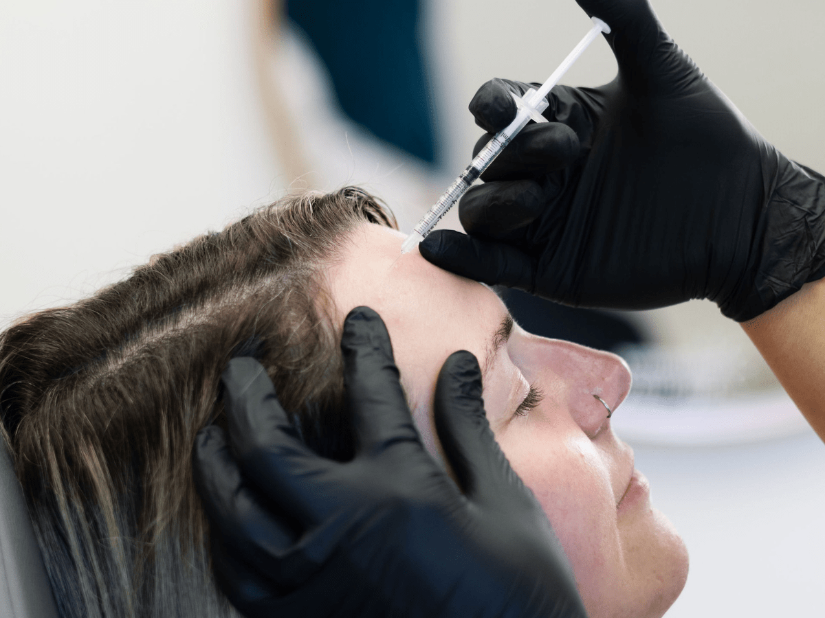 Client receiving a Botox injection in the forehead at New Age Medspa in Anchorage